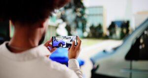 A car accident victim takes a photo at the accident scene. Learn more about what to do after a car accident that’s not your fault.